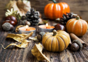 small pumpkins and candles on a table