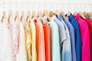 various colorful clothing pieces on hangers
