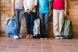 children with backpacks and new school clothes