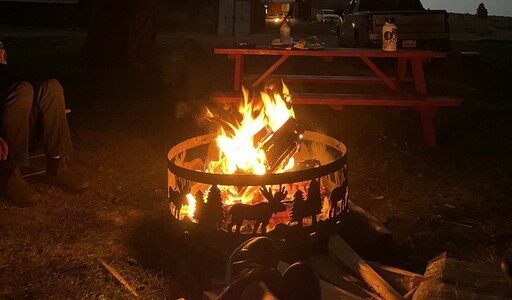 people sitting around their fire pit